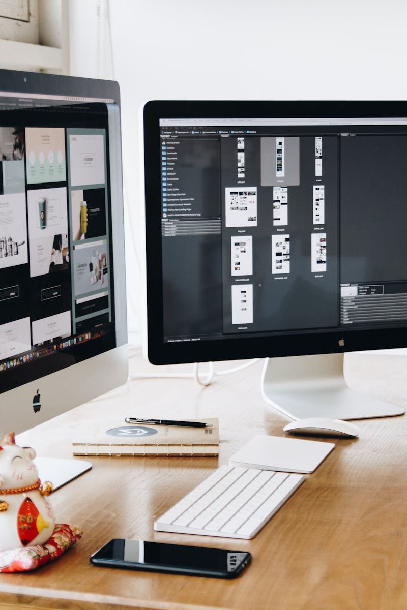 A well-organized design workspace with dual monitors and design software on display.